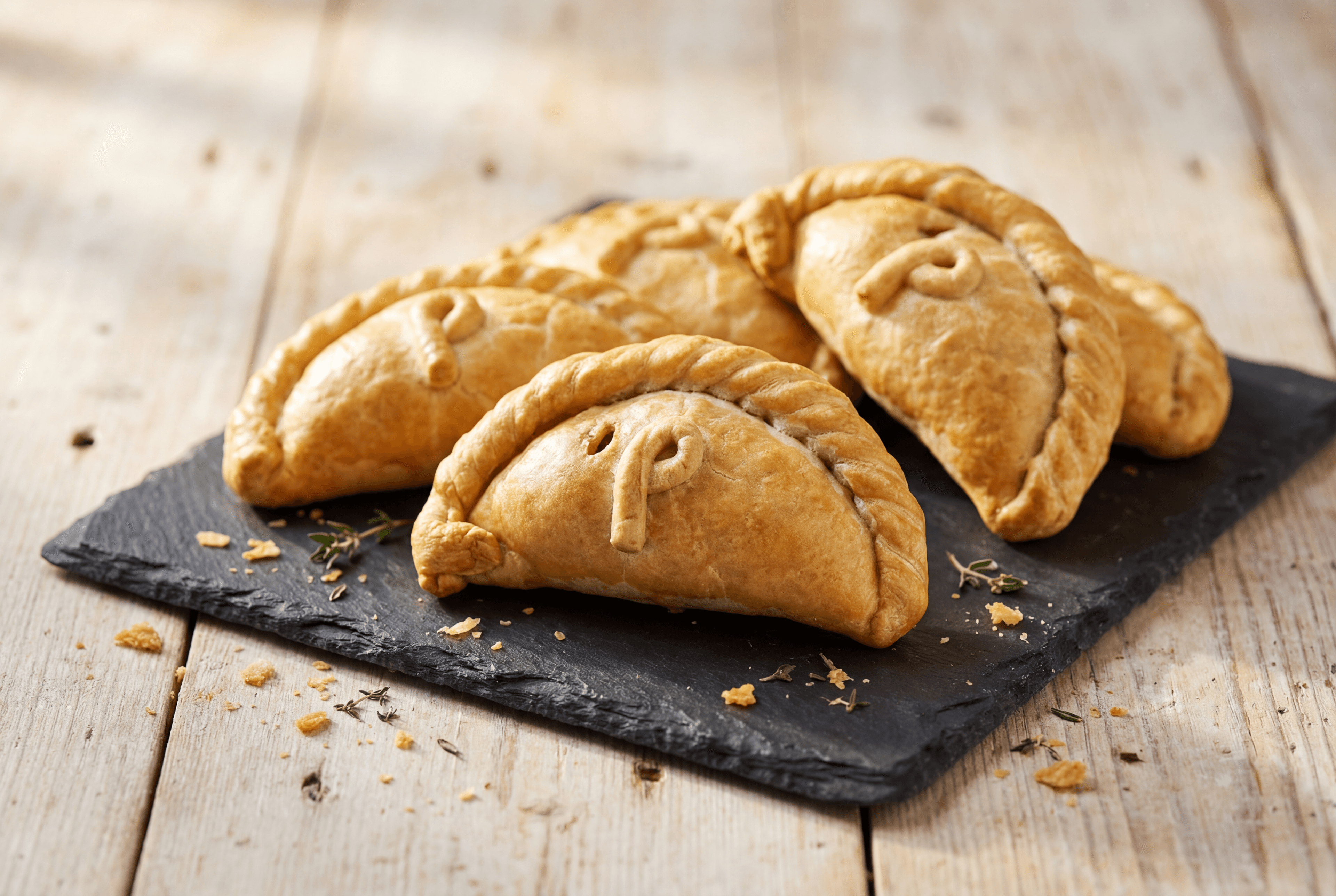 Four Philps cocktail-size pasties on a slate plate