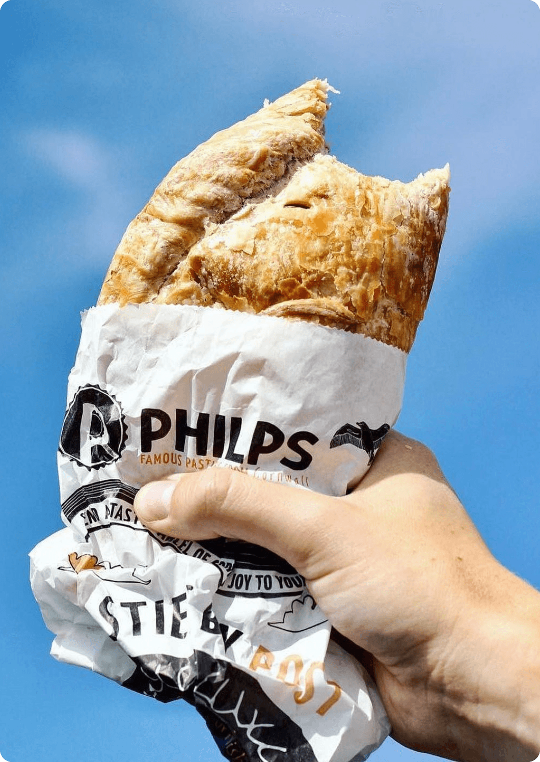 Philps branded cap held against blue sky