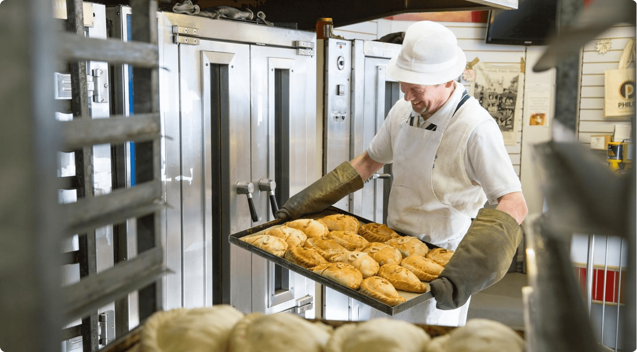 Baker at Philps loading a tray of pasties into the oven at the St Just bakery